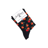 Chaussette femme moyenne noire à motifs oranges et feuilles vertes avec packaging Maison Broussaud.