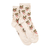 Paire de chaussettes blanches à motifs radis roses et verts, fantaisie pour femme, présentées à plat.