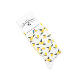 Paire de chaussettes femme mi-hautes blanches à motifs citrons jaunes et verts.