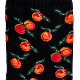 Détail du motif oranges et feuilles vertes sur chaussette femme noire.